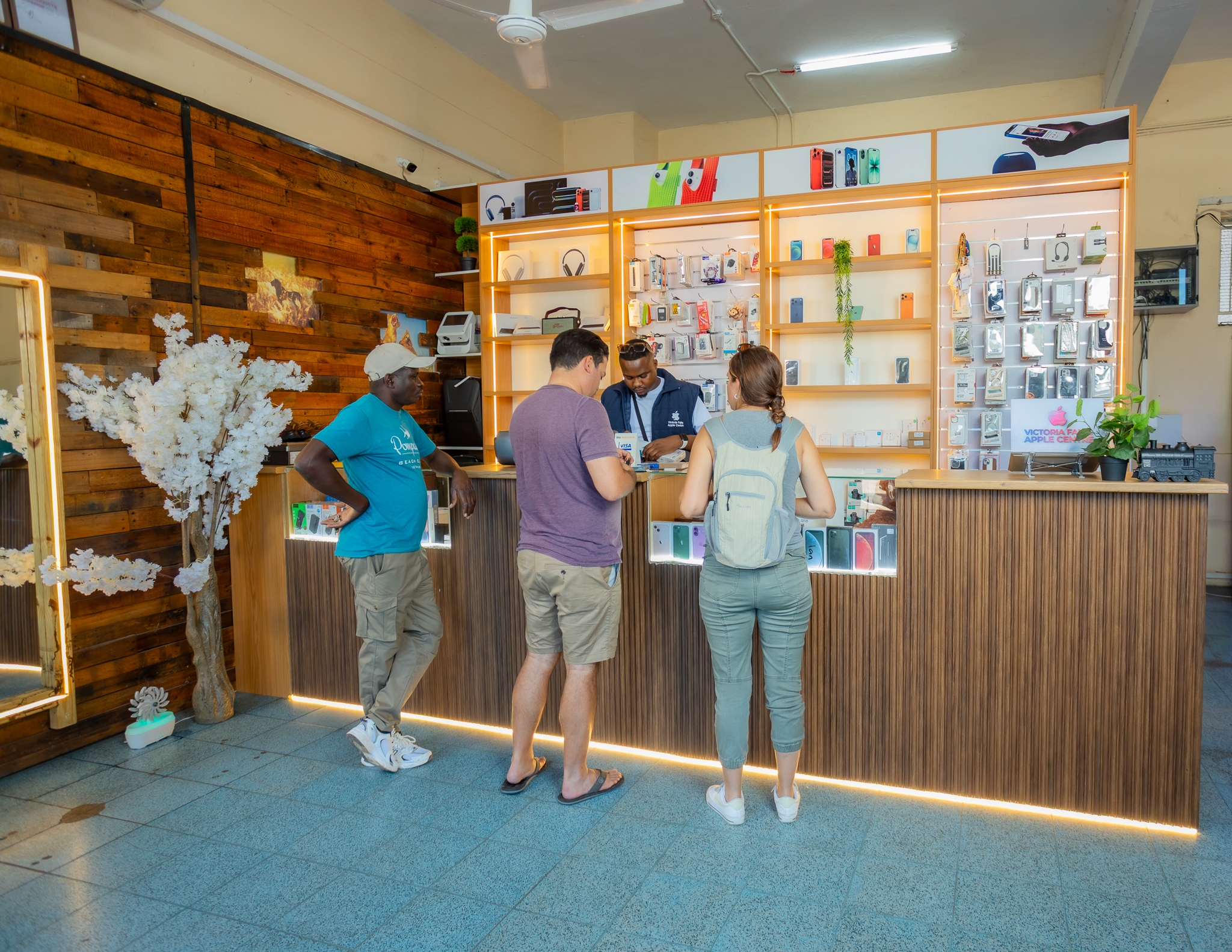 A staff member talking a customer through a device