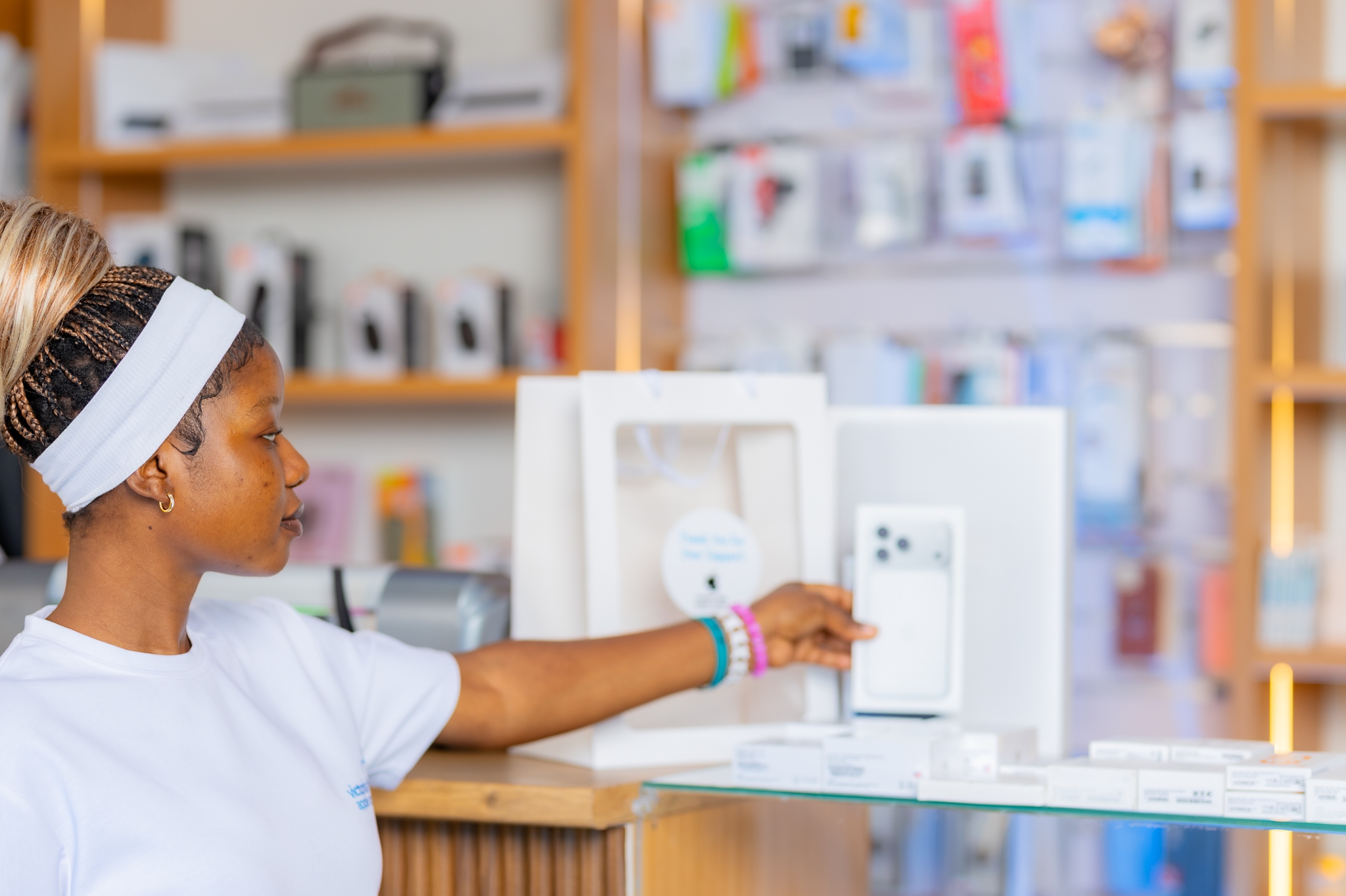 A staff member showing devices on the display counter