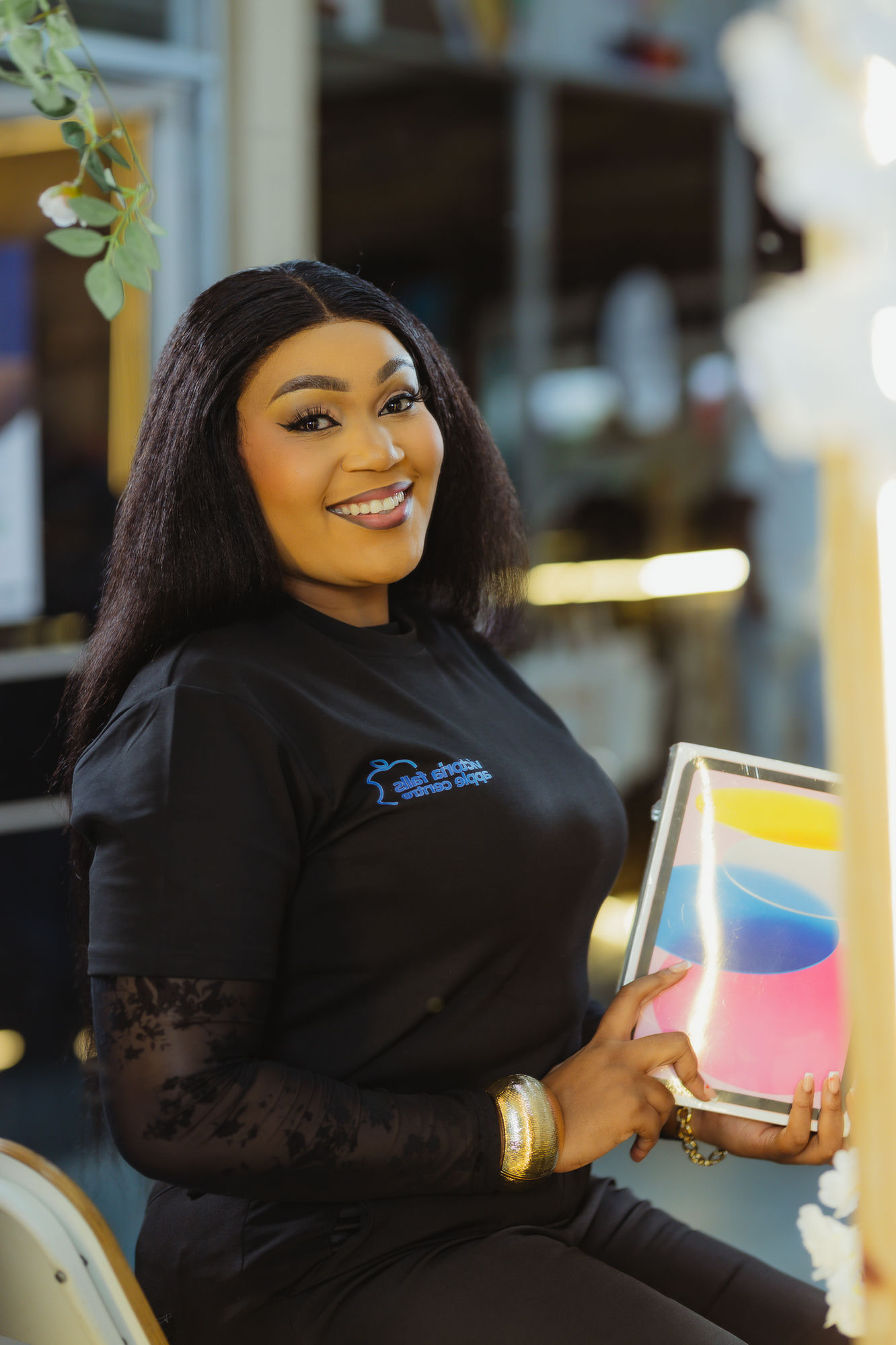 Victoria Falls Apple Centre staff member holding a new iPad