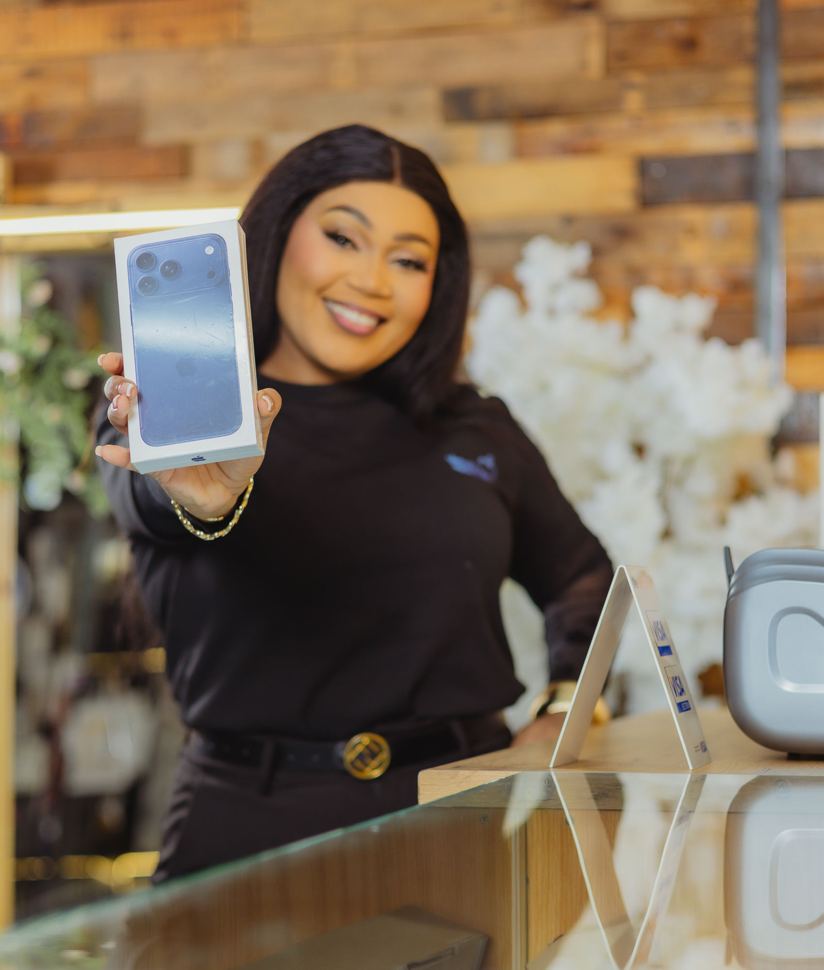 Staff member presenting a new iPhone box to a customer
